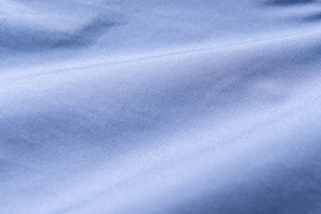 Closeup of rippled blue silk fabric, Blue fabric texture background,