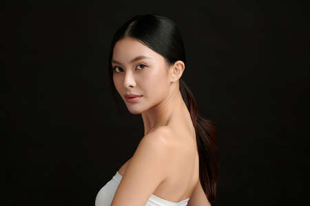 Beautiful young asian woman with clean fresh skin on black background, Face care, Facial treatment, Cosmetology, beauty and spa, Asian women portrait.の写真素材