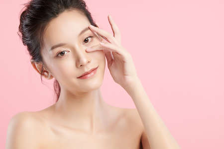 Beautiful young asian woman with clean fresh skin on pink background, Face care, Facial treatment, Cosmetology, beauty and spa, Asian women portrait.の写真素材
