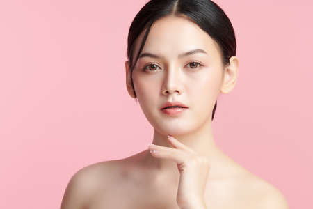 Beautiful young asian woman with clean fresh skin on pink background, Face care, Facial treatment, Cosmetology, beauty and spa, Asian women portrait.の写真素材