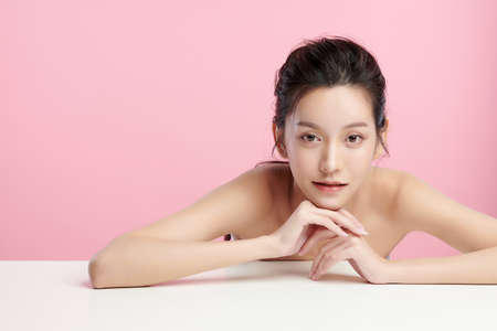 Beautiful young asian woman with clean fresh skin on pink background, Face care, Facial treatment, Cosmetology, beauty and spa, Asian women portrait.の写真素材