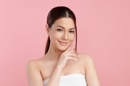 Beautiful young asian woman with clean fresh skin on pink background, Face care, Facial treatment, Cosmetology, beauty and spa, Asian women portrait.の写真素材