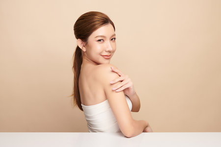 Beautiful young asian woman with clean fresh skin on beige background, Face care, Facial treatment, Cosmetology, beauty and spa, Asian women portrait.の写真素材