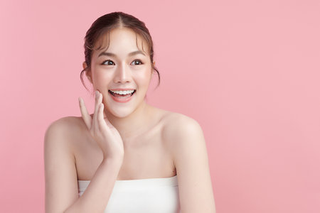 Beautiful smile of young woman with healthy white teeth on pink background, Dental care. Dentistry concept.の写真素材