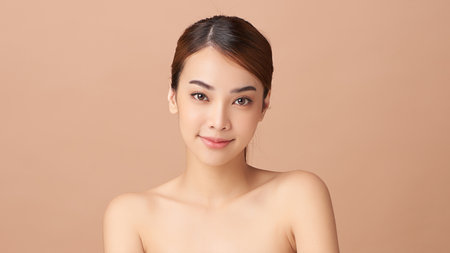 Beautiful young asian woman with clean fresh skin on beige background, Face care, Facial treatment, Cosmetology, beauty and spa, Asian women portrait.の写真素材
