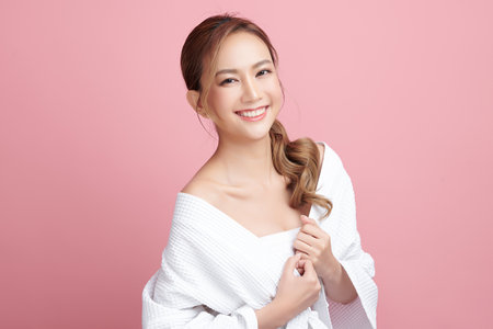 Beautiful young asian woman with clean fresh skin on pink background, Face care, Facial treatment, Cosmetology, beauty and spa, Asian women portrait.の写真素材