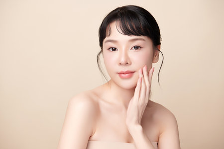 Beautiful young asian woman with clean fresh skin on beige background, Face care, Facial treatment, Cosmetology, beauty and spa, Asian women portrait.の写真素材