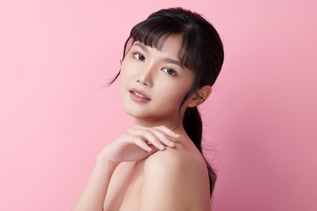 Beautiful young asian woman with clean fresh skin on pink background, Face care, Facial treatment, Cosmetology, beauty and spa, Asian women portrait.の写真素材