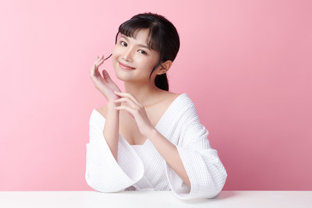 Beautiful young asian woman with clean fresh skin on pink background, Face care, Facial treatment, Cosmetology, beauty and spa, Asian women portrait.の写真素材