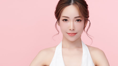 Beautiful young asian woman with clean fresh skin on pink background, Face care, Facial treatment, Cosmetology, beauty and spa, Asian women portrait.の写真素材