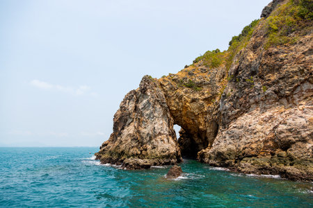 An island with a tunnel that can see through the other side of the seaの写真素材