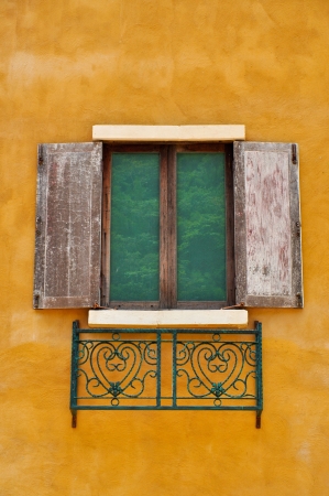 Vintage wooden windows on yellow wall texureの写真素材