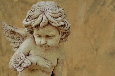 cupid sculpture with grunge backgroundの写真素材