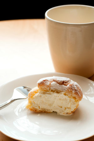 Choux pastry cream puffs on white plate