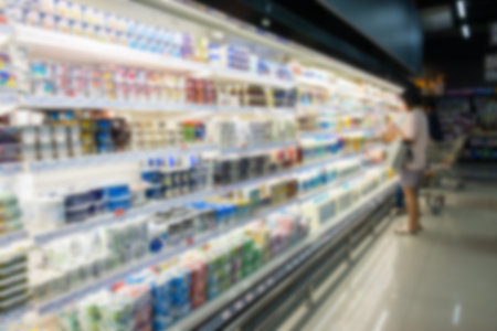 Defocused blur of supermarket shelves with dairy products. Blur backgroundの写真素材
