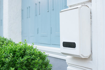 Post box on white wall with green nature, White Mailboxの写真素材