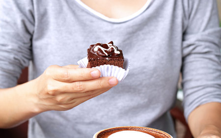 Women hand holding brownie cake.の写真素材