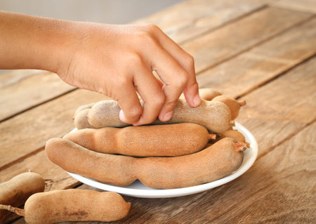 Hand picked sweet tamarinds put  on wooden tableの写真素材