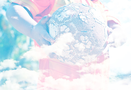 Creative double exposure portrait of young Asian boy combined with sky. (Let go to play soccer.)の写真素材