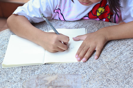 Children drawing on her note book.