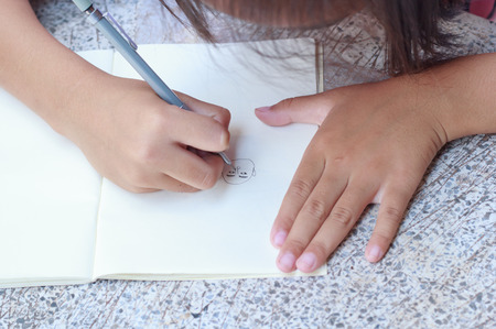 Children drawing on her note book.の写真素材