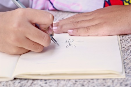 Child drawing in note book.の写真素材