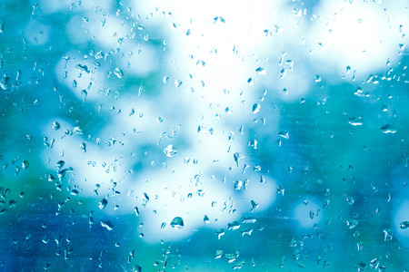 Water drop on the window on blue filtered blurred .の写真素材