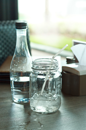Glass of drink water in table setting to lunch.の写真素材