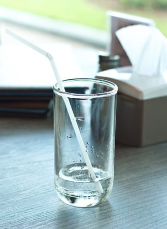 Glass of drink water in table setting to lunch.の写真素材