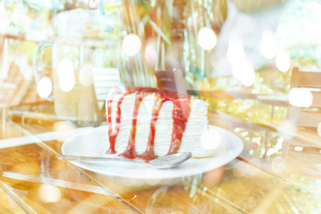 Creative double exposure  Crape cake with strawberry sauce with blurred background.