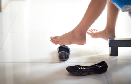 Soft photo of girl feet with her shoes.Focused on her foot.の写真素材