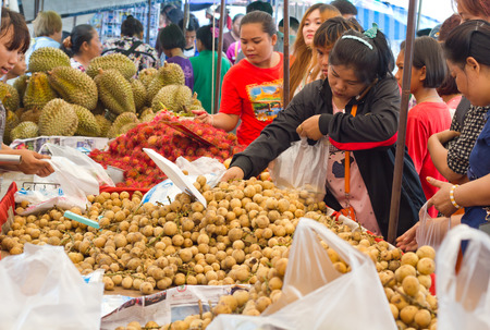 Nongkhai, Thailand - June 18: Unidentified  customers are selecting some fruit at Thai-Laos vintage market on Phonphisia in Nongkhai, Thailand on June 18, 2015.のeditorial素材