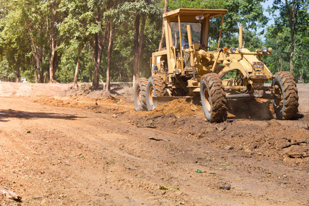 Nongkhai, Thailand - June 30: The Motorgrader  is grading of rural road construction between Ampher Phonphisia to Ampher Pak Kad in Nongkhai, Thailand on June 30, 2015.のeditorial素材
