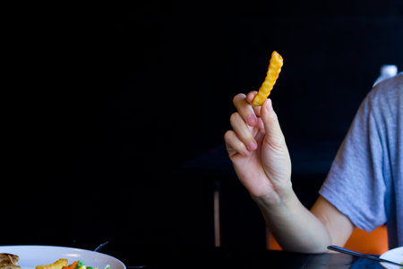 Hand holding french fries for eat.の写真素材
