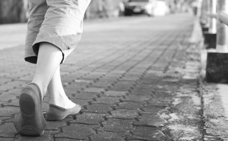 Black and white tone of Close up woman shoes walking on park street.の写真素材