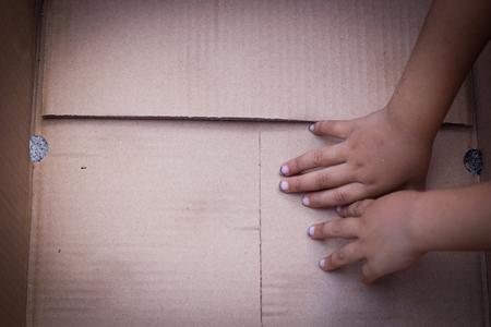 Paper box with Poor Children hands.の写真素材