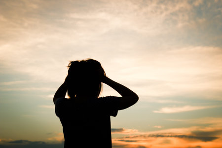 Silhouette of crazy asian woman over beautiful sunset background.の写真素材