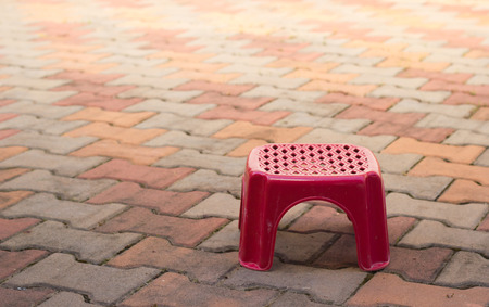 Small red chair on out door floor.の写真素材
