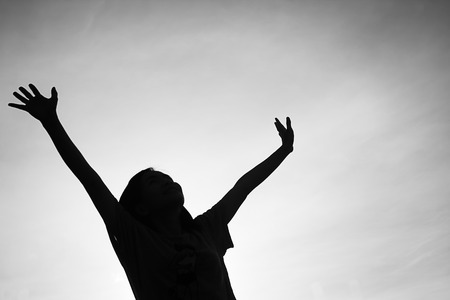 Silhouette of people hands up.の写真素材