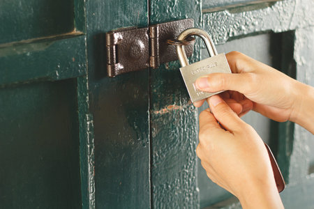 Asain woman hand locking the door.