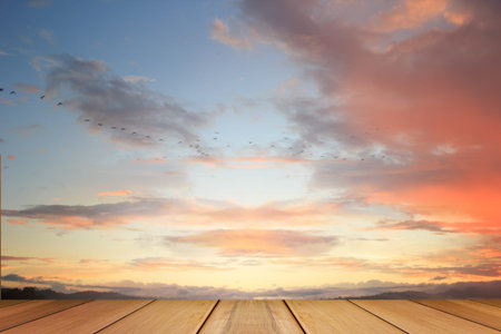 Scenery of sunset during twilight with wooden terrace.の写真素材