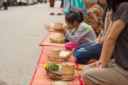 Loei province, THAILAND - NOVEMBER 8: Undefined People are preparing food for alms to Buddhist monks in walkway on November 8,2015 in Loei province, Thailand.のeditorial素材