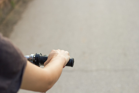 Women riding and travel. Bottom view, bicycles moving forward.の写真素材