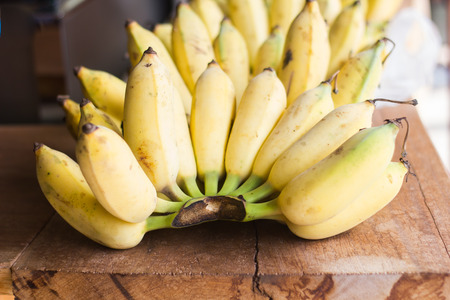 Bananas fruit put on wooden board.の写真素材