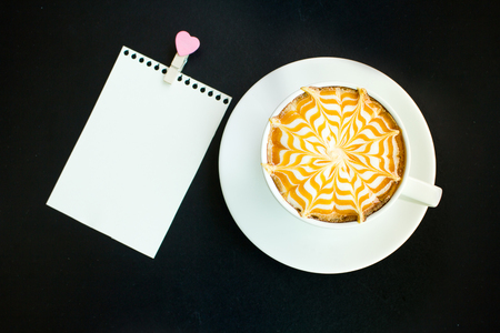 A Latte Coffee art on the black desk.の写真素材