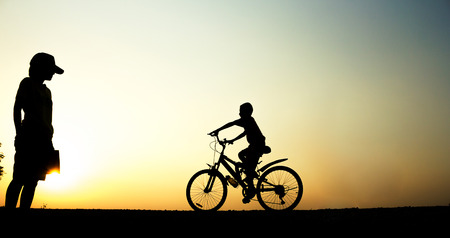 A boy fitness silhouette sunrise cycling workout wellness concept.の写真素材