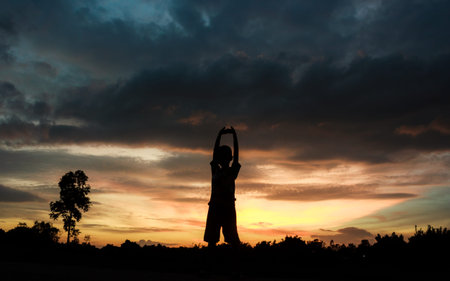 Fitness on silhouette sunrise The boy  workout wellness concept.