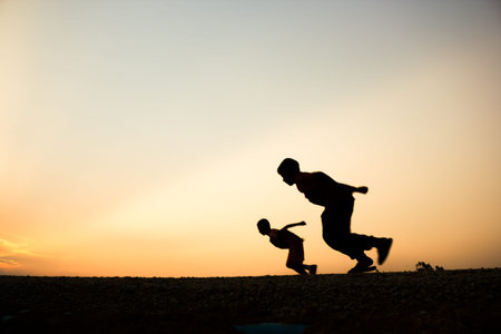 Fitness on silhouette sunrise The boy running workout wellness concept.