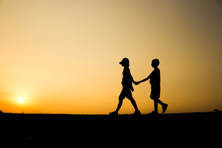 Fitness silhouette sunrise Holding Hands Walking workout wellness concept.の写真素材