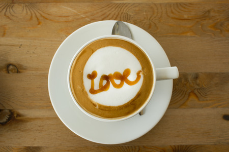 A Latte Coffee art on the wooden desk.A cup of coffee,coffee Art.の写真素材